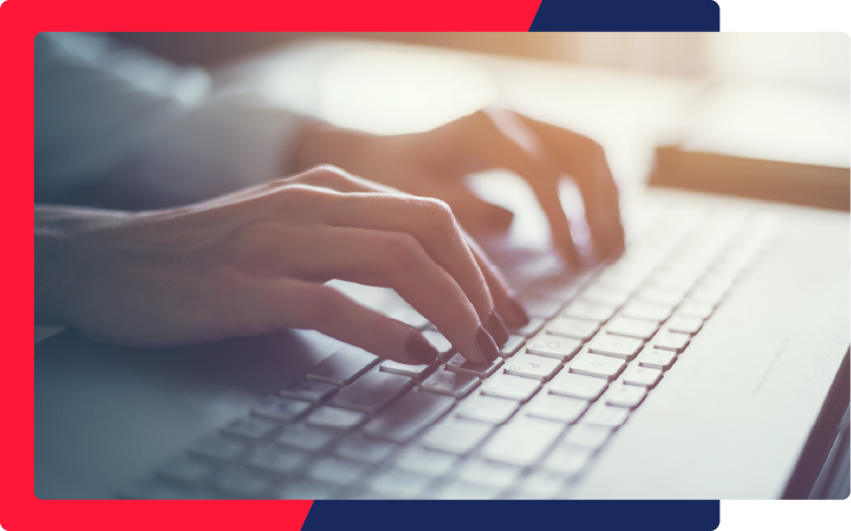 A lady typing on her keyboard to file a background check